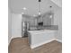 Modern kitchen with stainless steel appliances, gray cabinets, and a center island at 1533 Coastal Cove Ln, Calabash, NC 28467