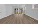 Open living room showcasing sliding doors to the backyard with new wood floors at 1533 Coastal Cove Ln, Calabash, NC 28467