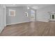 Contemporary living space featuring high ceilings, lots of windows, and sleek wood floors at 1533 Coastal Cove Ln, Calabash, NC 28467