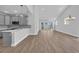 Bright living space featuring gray walls, wood floors, and sliding glass doors to the outside at 1533 Coastal Cove Ln, Calabash, NC 28467
