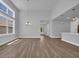 Spacious living area with tall ceilings, lots of natural light, and sleek wood floors at 1533 Coastal Cove Ln, Calabash, NC 28467