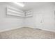 Versatile basement space with pegboard walls, overhead shelving, and a practical tile floor at 1533 Murrells Landing Rd., Conway, SC 29526