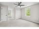 Bright bedroom with carpet, ceiling fan, and natural light from window and doorway with window seat at 1533 Murrells Landing Rd., Conway, SC 29526