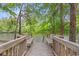 Inviting wooden dock featuring built-in benches, offering a serene waterfront view with lush greenery at 1533 Murrells Landing Rd., Conway, SC 29526