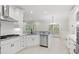Modern kitchen featuring white cabinets, stainless steel appliances, and an adjacent dining area at 1533 Murrells Landing Rd., Conway, SC 29526