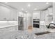 Bright kitchen features white cabinets, granite countertops, stainless steel appliances, and a breakfast bar at 1533 Murrells Landing Rd., Conway, SC 29526