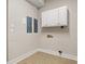 Functional laundry room with white cabinets, neutral walls, and tile flooring at 1533 Murrells Landing Rd., Conway, SC 29526