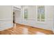 Bright living room with hardwood floors, large windows, and detailed trim at 1533 Murrells Landing Rd., Conway, SC 29526