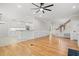 Open-concept living space with hardwood floors, a modern kitchen, and a staircase at 1533 Murrells Landing Rd., Conway, SC 29526