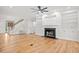 Cozy living room with hardwood floors, built-in shelves, a fireplace, and staircase at 1533 Murrells Landing Rd., Conway, SC 29526