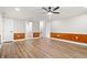Spacious living area featuring hardwood floors, modern ceiling fan, and stylish wood-paneled walls at 1533 Murrells Landing Rd., Conway, SC 29526