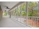 Expansive screened-in porch with a scenic view, ceiling fans, and white railing at 1533 Murrells Landing Rd., Conway, SC 29526