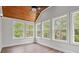 Bright sunroom boasts vaulted wood ceiling and multiple windows, offering serene views of the outdoors at 1533 Murrells Landing Rd., Conway, SC 29526
