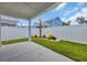 Covered patio with a well maintained fenced backyard and plush green grass at 1549 Coastal Cove Ln, Calabash, NC 28467