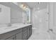 The bathroom features a double sink vanity, a large mirror and a spacious glass shower at 1549 Coastal Cove Ln, Calabash, NC 28467