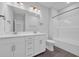 A newly renovated bathroom has double sinks and a shower with modern fixtures at 1549 Coastal Cove Ln, Calabash, NC 28467