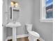 A newly renovated bathroom has a single sink and toilet with modern fixtures at 1549 Coastal Cove Ln, Calabash, NC 28467