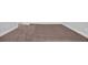 The carpeted floor of the empty bedroom has base molding and neutral walls at 1549 Coastal Cove Ln, Calabash, NC 28467