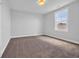 Empty bedroom with natural light, neutral walls, and carpeting at 1549 Coastal Cove Ln, Calabash, NC 28467