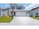 Charming two-story home featuring a two-car garage, a well-manicured lawn, and beautiful exterior paint at 1549 Coastal Cove Ln, Calabash, NC 28467