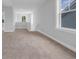Bright hallway featuring neutral walls, plush carpeting, and natural light from large windows at 1549 Coastal Cove Ln, Calabash, NC 28467