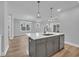 Stylish kitchen island features seating, pendant lighting, stainless steel appliances, and elegant cabinetry at 1549 Coastal Cove Ln, Calabash, NC 28467