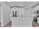 Modern kitchen featuring an island with pendant lighting, stainless steel appliances, and white cabinetry at 1549 Coastal Cove Ln, Calabash, NC 28467