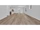 Bright living room with hardwood floors and access to an open-concept kitchen with modern appliances at 1549 Coastal Cove Ln, Calabash, NC 28467