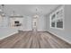 Bright living room features wood-look flooring, recessed lighting, and a large window with backyard views at 1549 Coastal Cove Ln, Calabash, NC 28467