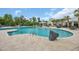 Resort-style pool with lounge chairs, umbrellas, and a beautifully landscaped area at 1549 Coastal Cove Ln, Calabash, NC 28467