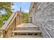 Wooden stairs leading to the backyard deck, offering a private outdoor space at 1566 Bessent Ave., Little River, SC 29566