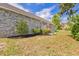 A charming brick home with a wooden deck, surrounded by a lush green lawn and beautiful landscaping at 1566 Bessent Ave., Little River, SC 29566