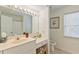 Well-lit bathroom featuring a vanity with a large mirror, offering a clean and functional space at 1566 Bessent Ave., Little River, SC 29566
