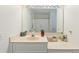 Clean bathroom featuring a vanity with ample counter space, a large mirror, and white cabinets at 1566 Bessent Ave., Little River, SC 29566
