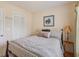 Bedroom with patterned comforter, grey walls, neutral carpet, wood blinds, curtains, and bedside table at 1566 Bessent Ave., Little River, SC 29566