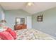 Bedroom with floral bedding, neutral carpet, sage green walls, ceiling fan, and wooden dressers at 1566 Bessent Ave., Little River, SC 29566