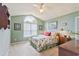 Bedroom featuring vaulted ceiling, large window and floral bedding, with sage green walls and neutral carpet at 1566 Bessent Ave., Little River, SC 29566