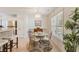 Charming dining area featuring a round glass table and a large window for plenty of natural light at 1566 Bessent Ave., Little River, SC 29566