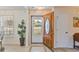 Bright entryway with tiled flooring, a decorative plant, and a partially open wooden front door at 1566 Bessent Ave., Little River, SC 29566