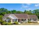 Charming single-story home with well-maintained landscaping and a welcoming front porch at 1566 Bessent Ave., Little River, SC 29566