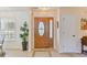 Warm and inviting foyer with a decorative wooden door, tiled flooring, and a bright window at 1566 Bessent Ave., Little River, SC 29566