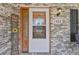 Close-up of the front door showing the brick facade, house number, and a 'Welcome' sign at 1566 Bessent Ave., Little River, SC 29566