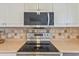 Close-up of a kitchen featuring updated stainless steel appliances and white cabinetry at 1566 Bessent Ave., Little River, SC 29566