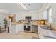 Modern kitchen with stainless steel appliances, ample counter space, and a breakfast bar area at 1566 Bessent Ave., Little River, SC 29566