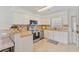 An open kitchen has white cabinets, stainless steel appliances, tile backsplash, and tile floor at 1566 Bessent Ave., Little River, SC 29566