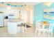 Open-concept kitchen with white cabinetry, countertops, and bar seating at 1605 S Ocean Blvd. # 1909, Myrtle Beach, SC 29577