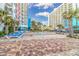Outdoor pool surrounded by patio with palm trees and lounge chairs at 1605 S Ocean Blvd. # 1909, Myrtle Beach, SC 29577