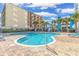 Outdoor pool with poolside lounge chairs and palm trees at 1605 S Ocean Blvd. # 1909, Myrtle Beach, SC 29577