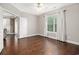 Bedroom with neutral walls, hardwood floors, large window and open doorway at 189 Ella Kinley Circle # 201, Myrtle Beach, SC 29588