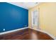 Well-lit bedroom showcases hardwood floors, a bright window, and vibrant accent wall at 189 Ella Kinley Circle # 201, Myrtle Beach, SC 29588